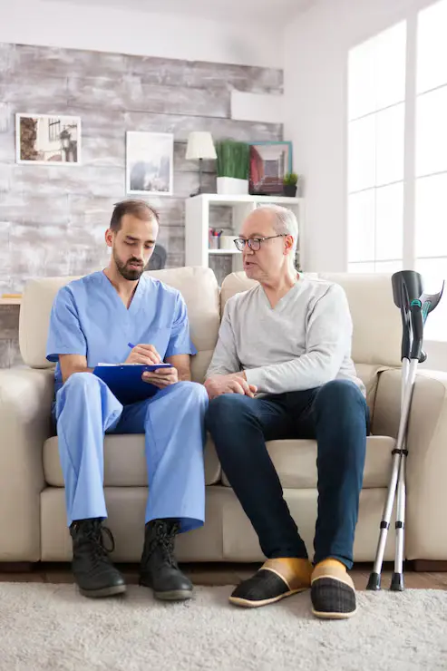 Caregiver holding hands with senior patient